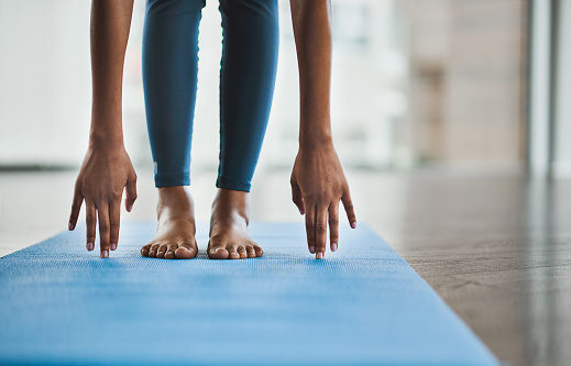 shot-of-an-unrecognisable-woman-practicing-a-yoga-routine-at-home